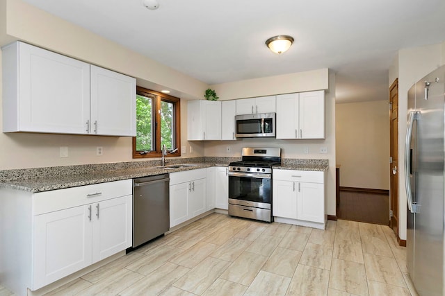 219 N Nina St, Cortland, IL 60112 - kitchen featuring appliances with stainless steel finishes, white cabinets, and light stone countertops