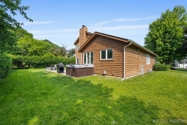 978 Merrimac Cir, Naperville, IL 60540 - rear view of house featuring a hot tub, a chimney, a lawn, and a patio
