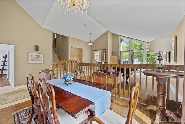 978 Merrimac Cir, Naperville, IL 60540 - dining space featuring vaulted ceiling, wood finished floors, stairs, and a chandelier