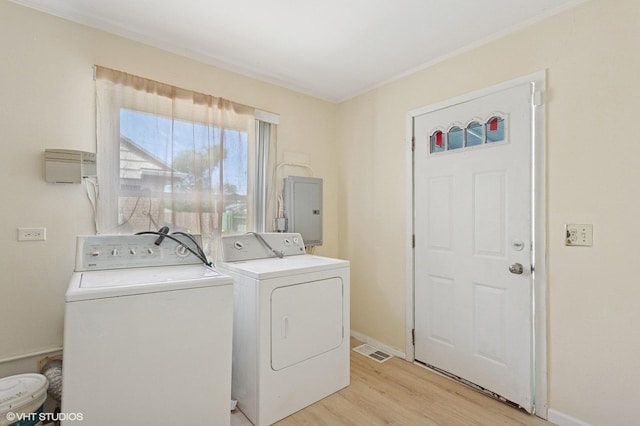 1113 Bristol Ave, Westchester, IL 60154 - washroom featuring washing machine and dryer, electric panel, and light wood-type flooring