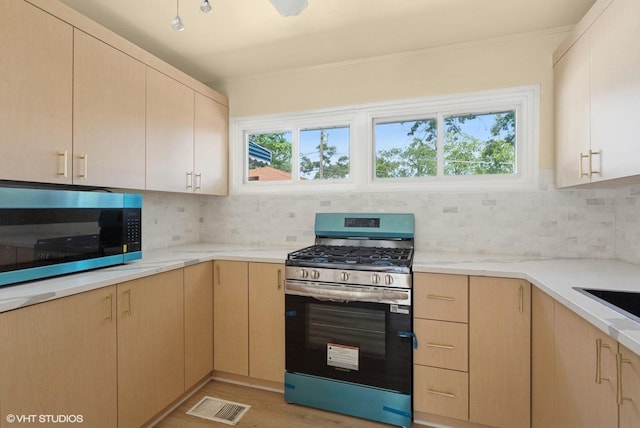 1113 Bristol Ave, Westchester, IL 60154 - kitchen featuring stainless steel gas range, backsplash, light brown cabinets, ornamental molding, and light stone countertops