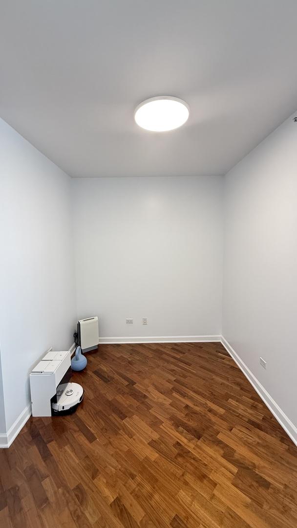 1841 S Calumet Ave Unit 2102, Chicago, IL 60616 - unfurnished room with dark wood-style flooring