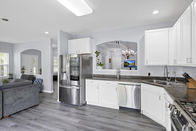 1850 Maureen Dr, Hoffman Estates, IL 60192 - kitchen with appliances with stainless steel finishes, open floor plan, dark countertops, white cabinets, and recessed lighting