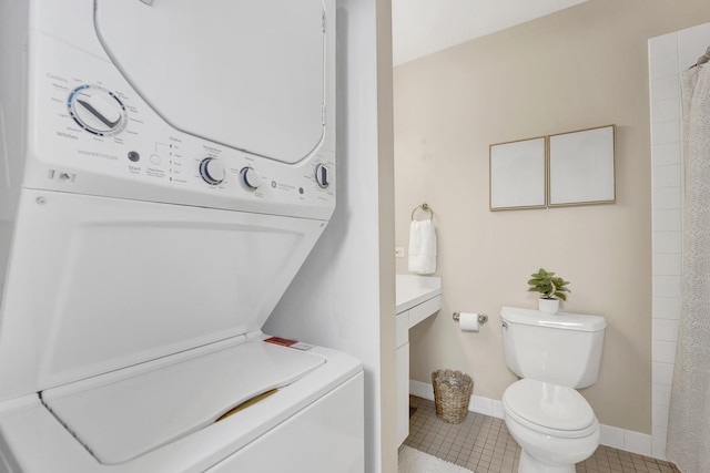 1315 W Webster Ave, Chicago, IL 60614 - bathroom featuring stacked washer / dryer, vanity, tile patterned floors, and a shower with shower curtain