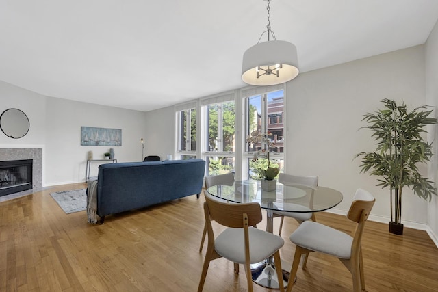 1315 W Webster Ave, Chicago, IL 60614 - dining room with light wood-style flooring and a fireplace with flush hearth