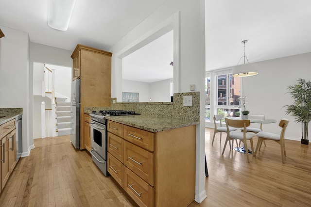 1315 W Webster Ave, Chicago, IL 60614 - kitchen with appliances with stainless steel finishes, light wood finished floors, light stone counters, and backsplash