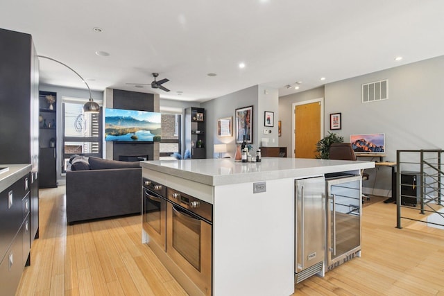1529 W Chestnut St Unit 102, Chicago, IL 60642 - kitchen with wine cooler, open floor plan, light countertops, and recessed lighting