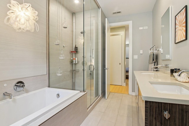 1529 W Chestnut St Unit 102, Chicago, IL 60642 - full bathroom with a garden tub, a shower stall, double vanity, and tile patterned floors