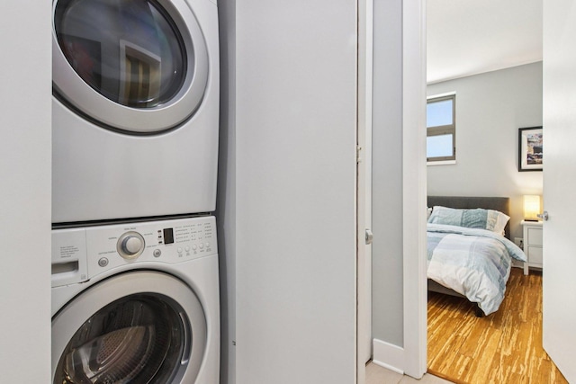 1529 W Chestnut St Unit 102, Chicago, IL 60642 - washroom with stacked washer / dryer and wood finished floors