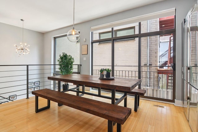 1529 W Chestnut St Unit 102, Chicago, IL 60642 - dining room with a chandelier, light wood-type flooring, and plenty of natural light