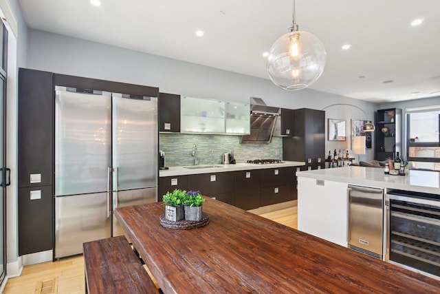 1529 W Chestnut St Unit 102, Chicago, IL 60642 - kitchen with wine cooler, stainless steel refrigerator, tasteful backsplash, light wood finished floors, and glass insert cabinets