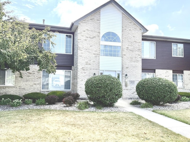 1411 Berta Dr Unit 2N, Crest Hill, IL 60403 - view of home's exterior featuring brick siding and a yard