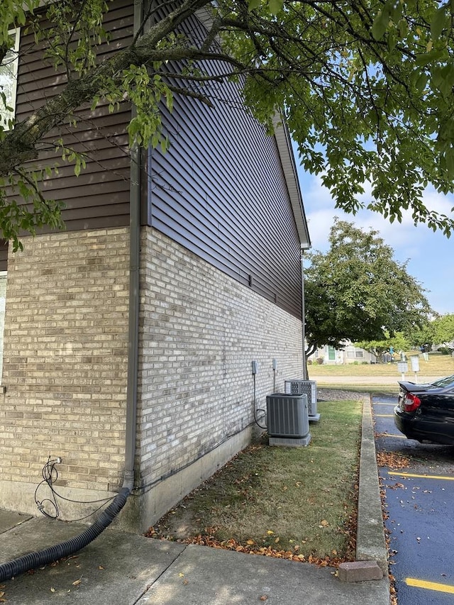 1411 Berta Dr Unit 2N, Crest Hill, IL 60403 - view of side of property with a central AC unit and brick siding