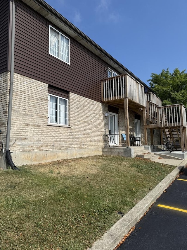 1411 Berta Dr Unit 2N, Crest Hill, IL 60403 - view of property exterior featuring brick siding and a yard