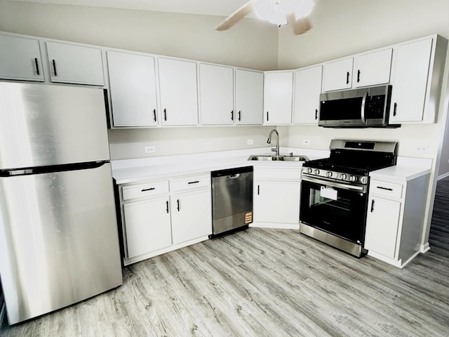 1411 Berta Dr Unit 2N, Crest Hill, IL 60403 - kitchen with appliances with stainless steel finishes, light wood-style floors, white cabinetry, light countertops, and vaulted ceiling