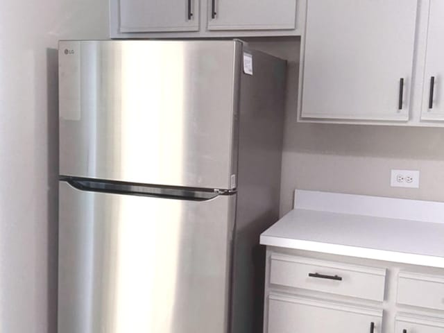 1411 Berta Dr Unit 2N, Crest Hill, IL 60403 - kitchen with freestanding refrigerator and light countertops
