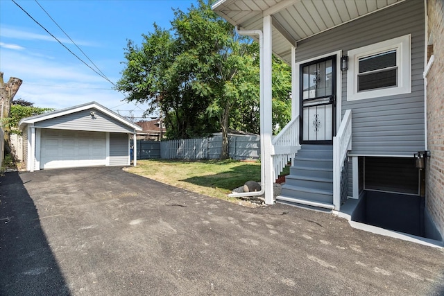 1706 S 9th Ave, Maywood, IL 60153 - view of side of home featuring an outdoor structure, a garage, and asphalt driveway