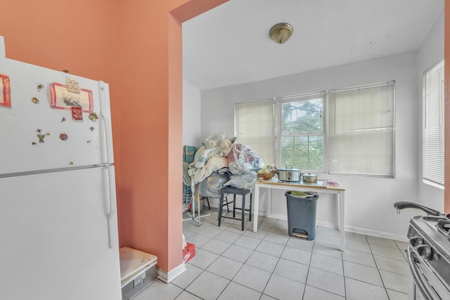 5347 S Racine Ave, Chicago, IL 60609 - kitchen with freestanding refrigerator, light tile patterned floors, and stainless steel range