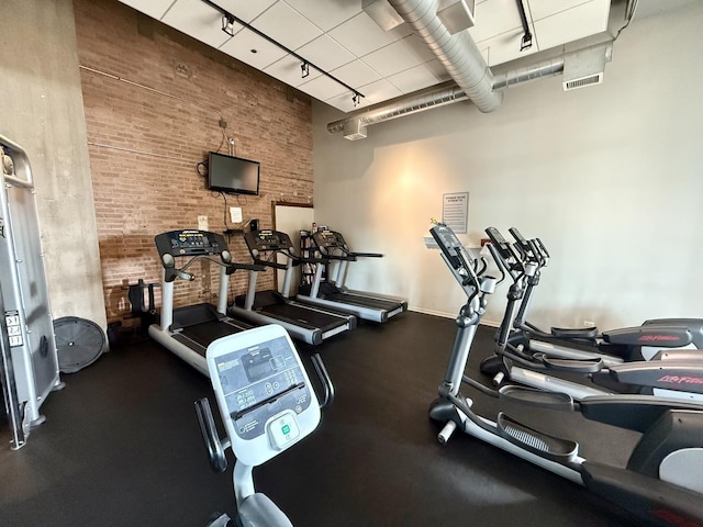 900 N Kingsbury St Unit 861, Chicago, IL 60610 - workout area with track lighting, a towering ceiling, and brick wall