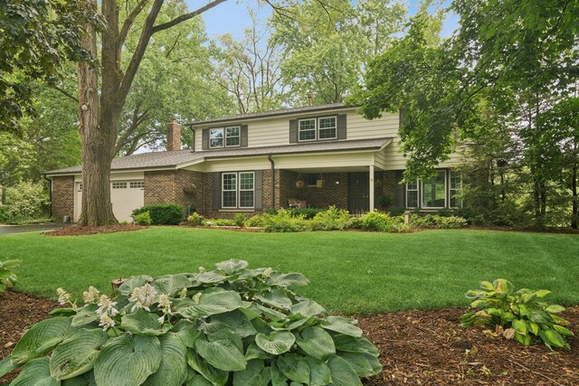 870 Georgetowne Ln, Barrington, IL 60010 - traditional home featuring a garage, a chimney, brick siding, and a front lawn