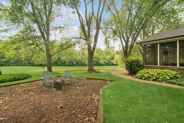 870 Georgetowne Ln, Barrington, IL 60010 - view of green lawn with an outdoor fire pit and a sunroom