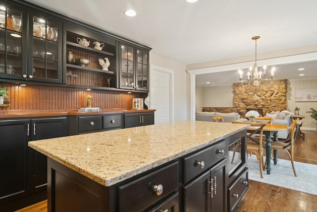 870 Georgetowne Ln, Barrington, IL 60010 - kitchen with dark wood finished floors, a chandelier, glass insert cabinets, stainless steel microwave, and a kitchen island
