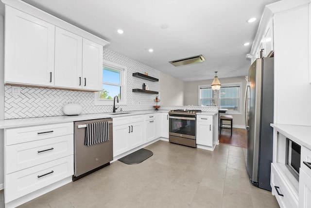 14424 S Pheasant Ln, Homer Glen, IL 60491 - kitchen with stainless steel appliances, a peninsula, backsplash, light countertops, and recessed lighting