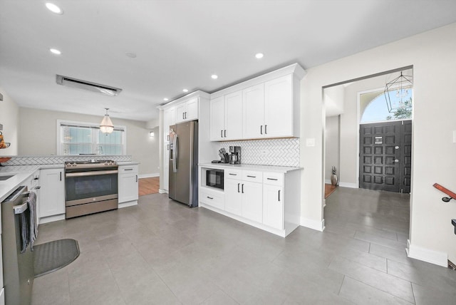14424 S Pheasant Ln, Homer Glen, IL 60491 - kitchen featuring stainless steel appliances, tasteful backsplash, light countertops, healthy amount of natural light, and recessed lighting