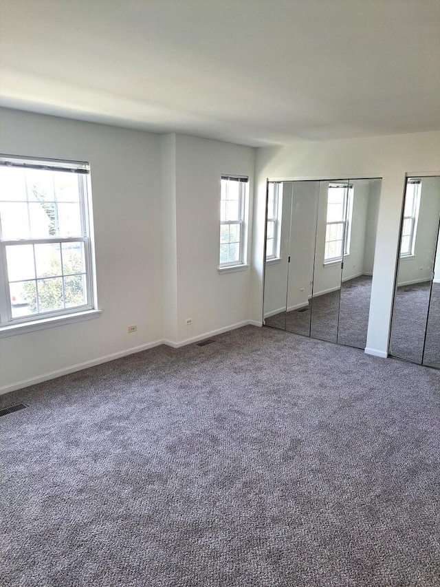 895 Clover Ln Unit 895, Pingree Grove, IL 60140 - unfurnished bedroom featuring carpet floors and multiple closets