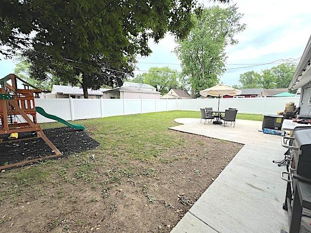 534 White Oak Rd, Bolingbrook, IL 60440 - fenced backyard with a patio and a playground