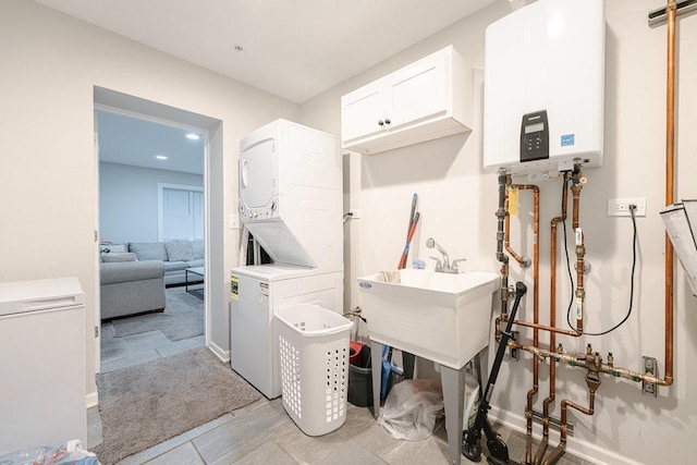 74 Marquette St, Park Forest, IL 60466 - laundry room featuring water heater, stacked washer / dryer, cabinet space, and recessed lighting