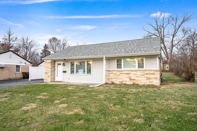 74 Marquette St, Park Forest, IL 60466 - view of front of home with stone siding, roof with shingles, and a front lawn