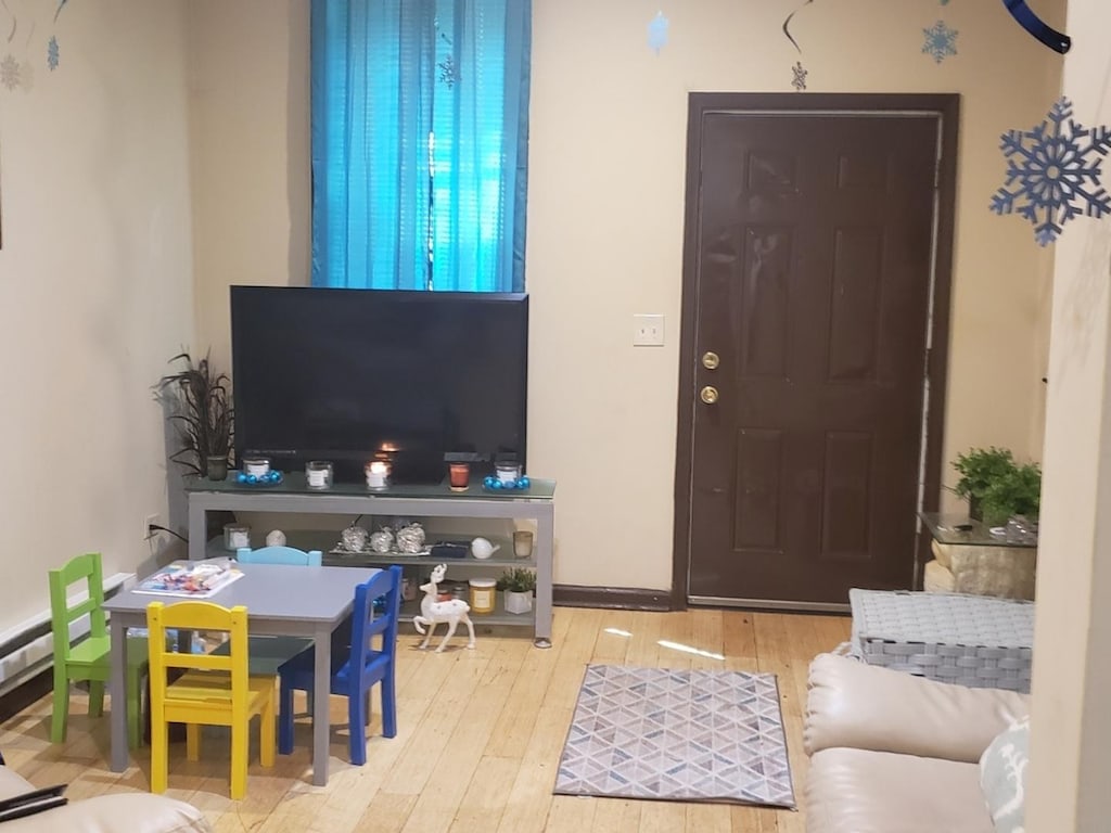 954 E 76th St, Chicago, IL 60619 - living room featuring wood finished floors