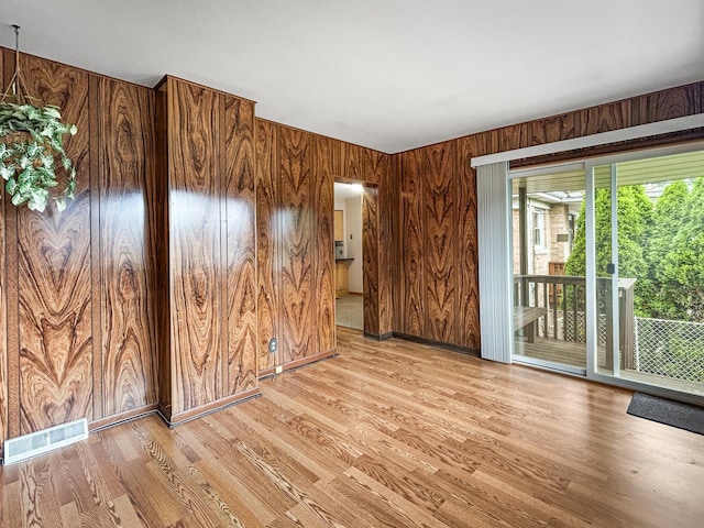 4841 N Natchez Ave, Chicago, IL 60656 - spare room with wooden walls and light wood finished floors