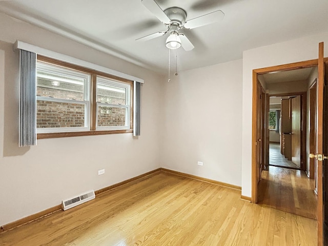 4841 N Natchez Ave, Chicago, IL 60656 - unfurnished room with light wood-style floors, plenty of natural light, and a ceiling fan