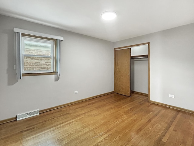4841 N Natchez Ave, Chicago, IL 60656 - unfurnished bedroom with light wood-style flooring and a closet