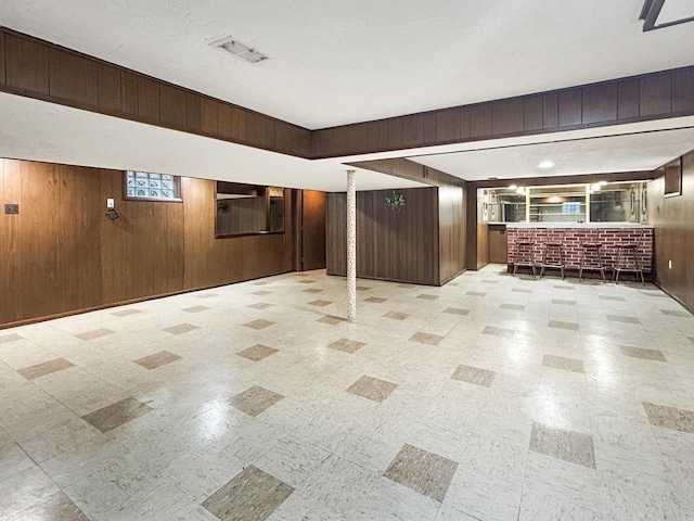 4841 N Natchez Ave, Chicago, IL 60656 - below grade area with wood walls, light floors, and bar