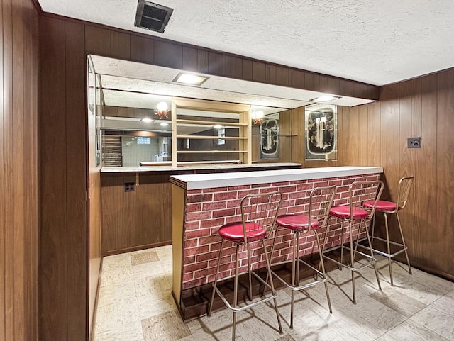4841 N Natchez Ave, Chicago, IL 60656 - indoor dry bar with light floors, wood walls, and a textured ceiling