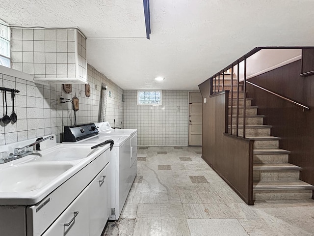 4841 N Natchez Ave, Chicago, IL 60656 - washroom featuring tile walls, independent washer and dryer, cabinet space, and a textured ceiling