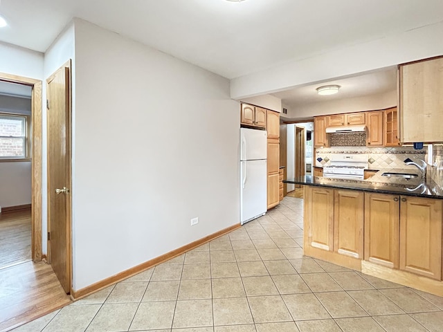 4841 N Natchez Ave, Chicago, IL 60656 - kitchen featuring white appliances, decorative backsplash, a peninsula, light tile patterned flooring, and under cabinet range hood