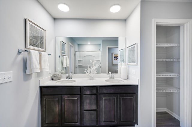 2893 Killarny Dr, Elgin, IL 60124 - full bath with double vanity, a shower, a spacious closet, and wood finished floors