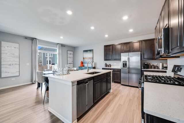 2893 Killarny Dr, Elgin, IL 60124 - kitchen featuring stainless steel appliances, light wood-type flooring, a kitchen island with sink, dark brown cabinets, and recessed lighting