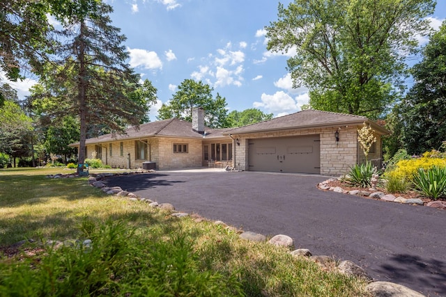 1090 Roselle Rd, Inverness, IL 60067 - ranch-style house with stone siding, driveway, a garage, a chimney, and a front lawn
