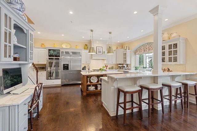 590 Merri Oaks Rd, Barrington Hills, IL 60010 - kitchen with stainless steel appliances, open shelves, decorative backsplash, a kitchen island with sink, and crown molding