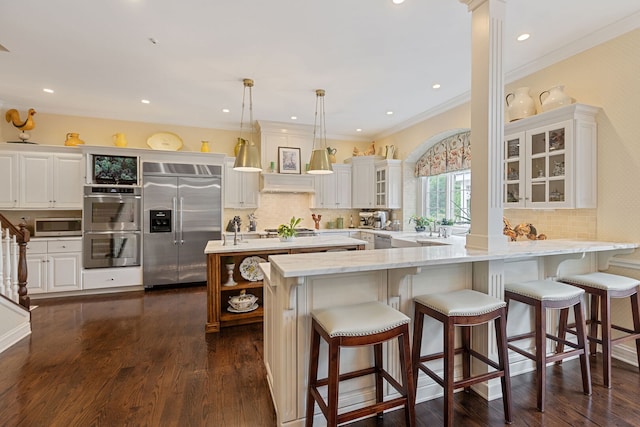 590 Merri Oaks Rd, Barrington Hills, IL 60010 - kitchen with appliances with stainless steel finishes, a center island with sink, backsplash, glass insert cabinets, and crown molding