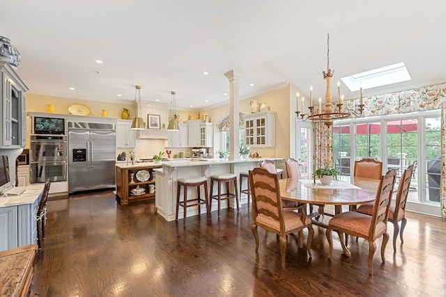 590 Merri Oaks Rd, Barrington Hills, IL 60010 - dining room with healthy amount of natural light, a chandelier, a skylight, dark wood-style floors, and ornamental molding