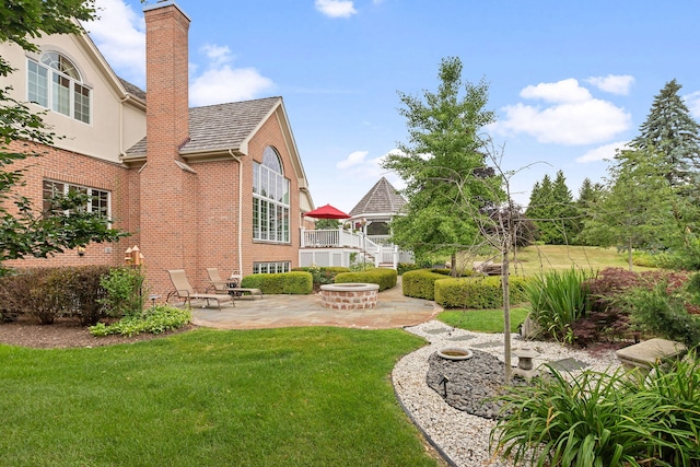 590 Merri Oaks Rd, Barrington Hills, IL 60010 - view of grassy yard with a patio and an outdoor fire pit