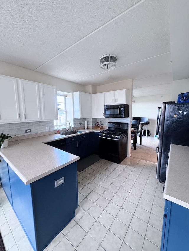 656 Pearson St Unit 512C, Des Plaines, IL 60016 - kitchen with black appliances, white cabinetry, a peninsula, light countertops, and backsplash