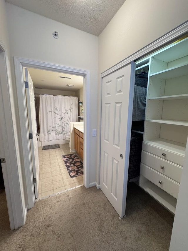 656 Pearson St Unit 512C, Des Plaines, IL 60016 - full bath featuring vanity, a textured ceiling, tile patterned flooring, carpet, and a closet