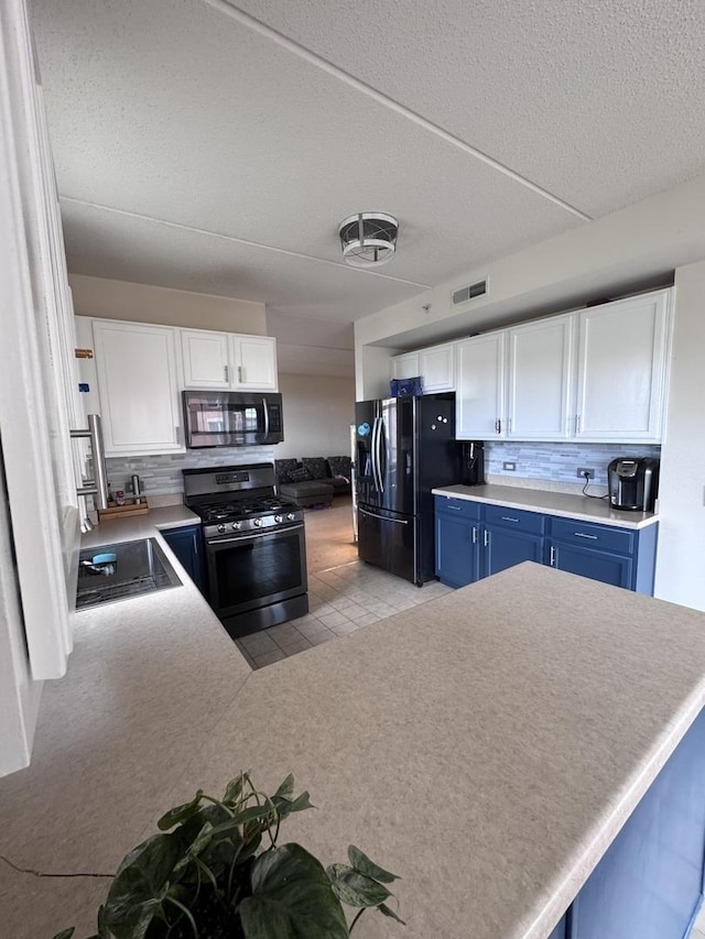 656 Pearson St Unit 512C, Des Plaines, IL 60016 - kitchen featuring black appliances, blue cabinetry, white cabinetry, decorative backsplash, and a textured ceiling